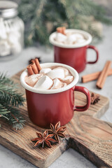 Two red enamel mugs with hot chocolate