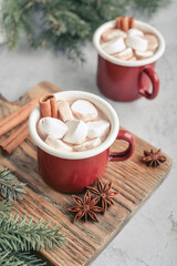 Two red enamel mugs with hot chocolate