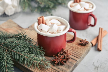 Two red enamel mugs with hot chocolate