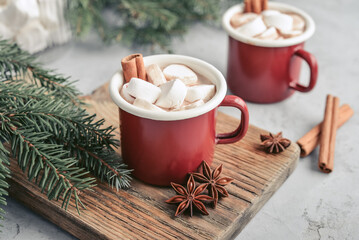 Two red enamel mugs with hot chocolate