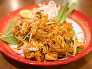 Savoring authentic pad thai local restaurant food cozy setting close-up culinary delight