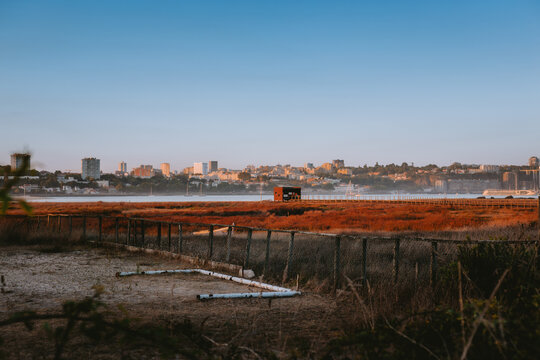 Birdwatching hut overlooking douro river estuary at sunset with porto skyline in background. Estu&aacute;rio do Douro Local Nature Reserve