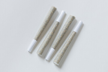 Clean overhead photo of Four Marijuana Joints on white background