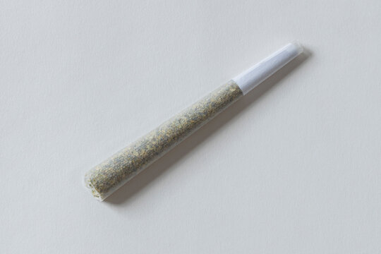 Detail of preroll Marijauana joint, cigarette on white background