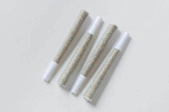 Clean overhead photo of Four Marijuana Joints on white background