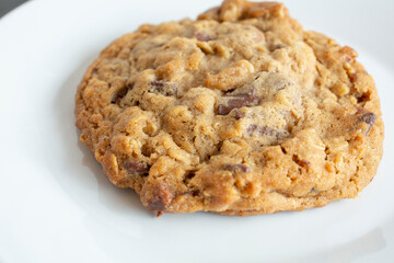 A closeup view of a chocolate chip oatmeal cookie.