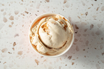 A top down view o a scoop of cheesecake ice cream.