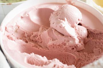 A view of a tub of strawberry ice cream.