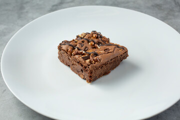 A view of a brownie, featuring pecan and chocolate chips.