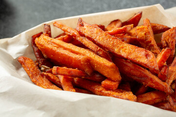 A closeup view of a tray of sweet potato fries.
