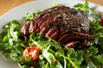 A closeup view of a steak salad.