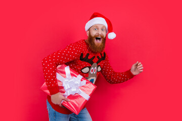 amazed man with xmas present. merry xmas. santa man hurry up with xmas present isolated on red