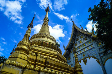 Fototapeta premium Chapel and Gold Pagoda, Lanna Architecture, Symbols of Buddhism, South East Asia at Ko Klang temple, Muang Chiang Mai, Chiang Mai, Northern Thailand