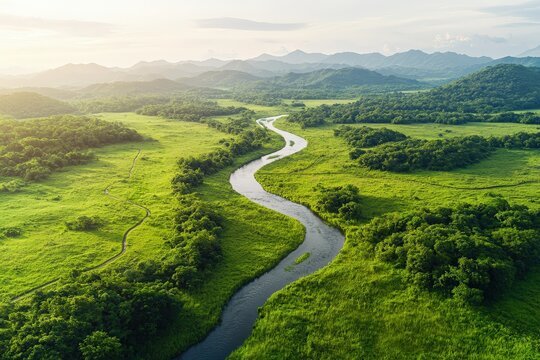 Serene Aerial View of Meandering River Through Lush Green Landscape in Mountains