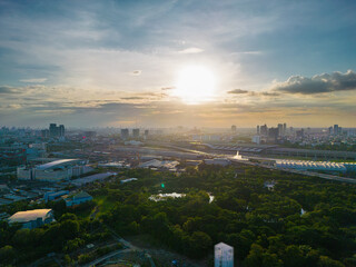 Aerial view green tropical rainforest with office building city public park blue sky evening sunset