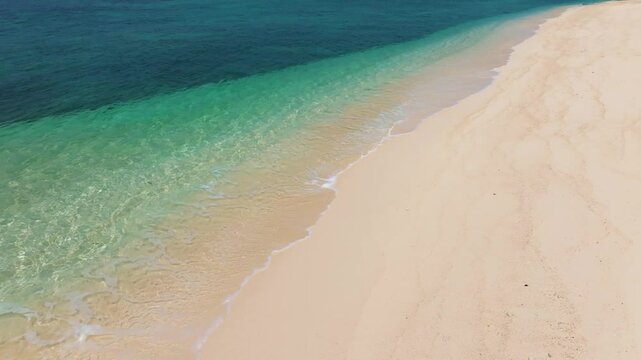 Sea waves on the beach, nature of the beach and the sea, summer with sunshine, sandy beach, sparkling blue sea contrasting with the beautiful sandy beach.