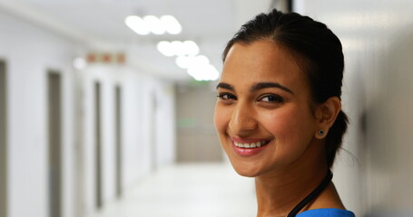 Portrait of female doctor standing in corridor in hospital