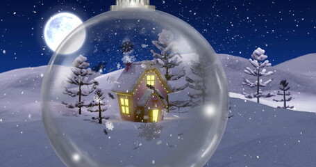 Fototapeta premium Image of winter scenery with house in snow globe over snow falling background