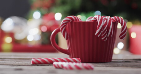 A red mug with candy canes signifies holiday cheer at home © vectorfusionart