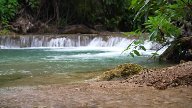 waterfall clear flow motion water with nature rocks and lichen on summer season for fresh relax on green trees in natural forest garden at huai mae khamin waterfall in national park with stream sound