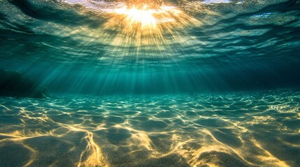 58.A serene view of bright sunlight streaming through the surface of the calm blue sea. The clean, clear waters reflect the golden rays, creating ripples on the surface while the light penetrates