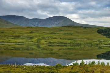 Epic dramatic landscape image of Three Sisters in Glencoe in Scottish Highlands on a wet Summer day. August 2020. This was during the Covid 19 Pandemic .