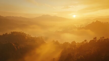 Warm golden sunrise over misty hills in a tranquil nature landscape