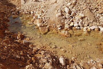 Water at the bottom of a limestone quarry