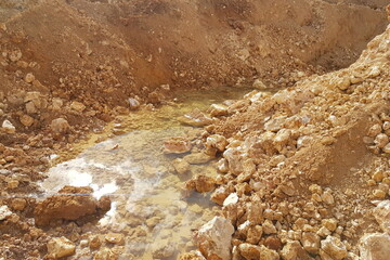 Water at the bottom of a limestone quarry