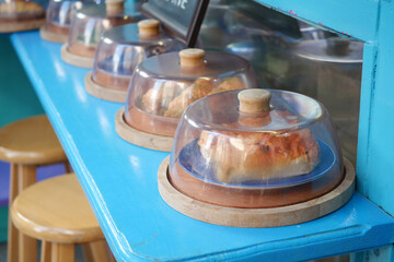 A Showcase of Delicious and Tempting Pastries Under a Glass Cloche Display