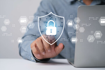 A close-up of a person interacting with a digital security shield on a laptop, symbolizing online...