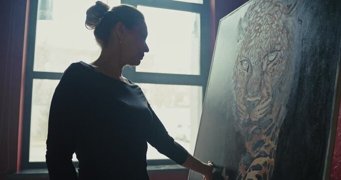 Artist Painting a Leopard in Her Studio at Dusk