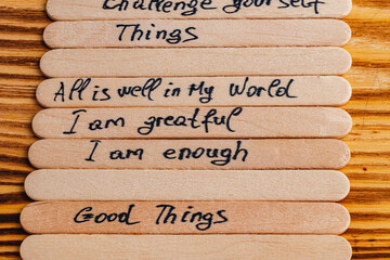 Positive thoughts for increasing selfesteem on wooden posts on wooden background