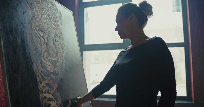 Artist Painting a Leopard in Her Studio at Dusk