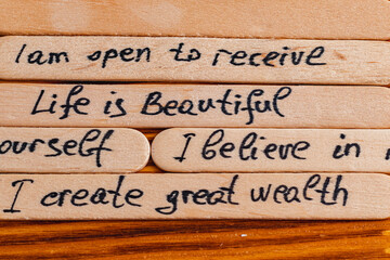 Positive thoughts for increasing selfesteem on wooden posts on wooden background