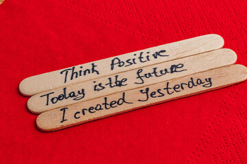Positive thoughts for increasing self-esteem on wooden posts on red background