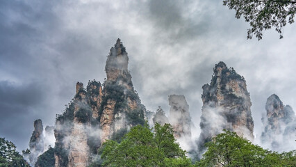 Amazing unusual mountains. Steep high cliffs with green vegetation on the slopes are surrounded by...