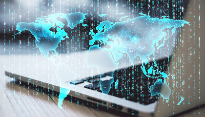 Digital global map hologram overlay on laptop keyboard, binary code background concept.