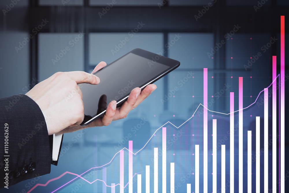 Poster hand holding tablet with financial graphs and data on screen in office background.
