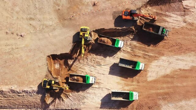 Aerial view road motor grader flatting dirt road surface, Motor grader road construction grader industrial machine construction site new road, Aerial view group excavator working on construction site.