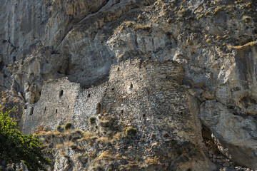 Dzivgis Fortress, Kurtatinsky Gorge, Republic of North Ossetia-Alania, Russia. Medieval Ossetian rock fortress. Stone fortress walls built on rocks. Ancient defensive structures. Historical landmark.