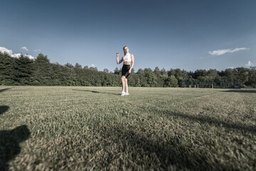 Portrait of a young beautiful athletic girl in the summer outdoors.