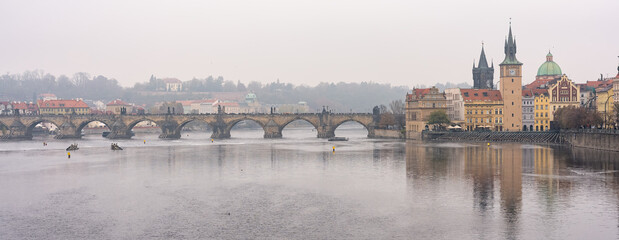 Great panoramic view of the Vltava River and Charles Bridge on a foggy day, Prague.