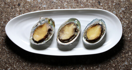 Korea's healthy abalone. Fresh abalone on a white plate.
