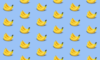 popular seamless repeating texture of ripe and tasty bananas on blue background. print