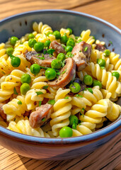 Delicious bowl of pasta carbonara topped with peas, fresh herbs, and champignon served outdoors on a sunny day