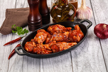 Raw marinated buffalo chicken wings