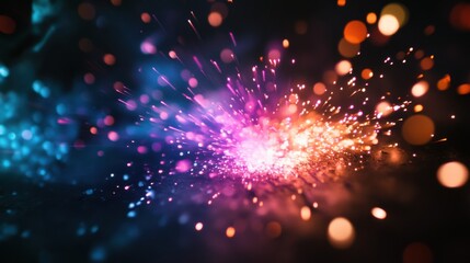 Obraz premium A mesmerizing image of abstract, colorful sparks converging to create a unified, radiant burst on a dark surface