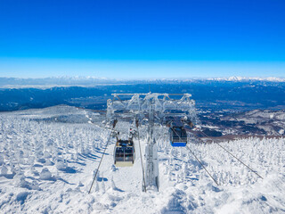 Cablecars passing above the forest of ice monsters (Zao, Yamagata, Japan)