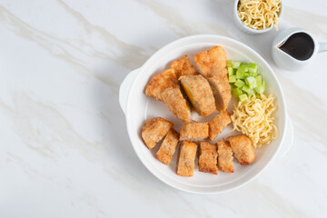 Pempek, traditional food from South Sumatra, Indonesia. This fish-based food is very popular. Served with cuko sauce and cucumber slices. Perfect for recipe, article, catalogue.